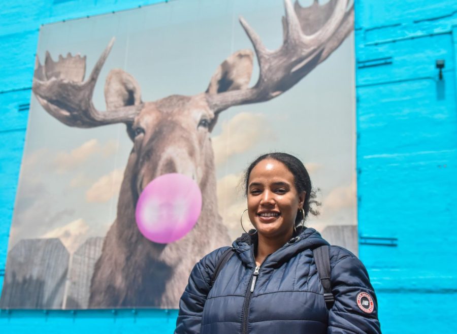 Rosemary Morillo, a senior broadcast journalism major, poses in front of the iconic wall-art of a moose blowing a pink bubblegum bubble at 33 E. Ida B. Wells Dr. on Friday, April 21, 2023. Morillo is a Marines veteran and the president of the Student Veterans Organization at Columbia.