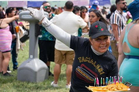 Martha Cruz, wife of The Tamale Guy owner Claudio Velez, strikes a pose as she hands out samples of tamales to attendees of the Sueños Music Festival in Grant Park on May 28, 2023.