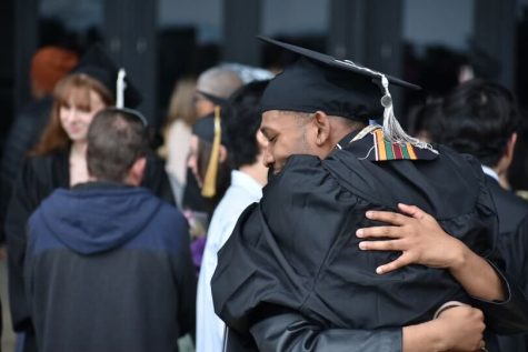 A Columbia graduate embraces a family member after receiving their diploma on Saturday, May 13, 2023. The colleges 2022-2023 commencement was broken up into four different ceremonies by department and was held at the Arie Crown Theatre, located at 2301 Jean Baptist Pt. DuSable Lake Shore Dr. 
