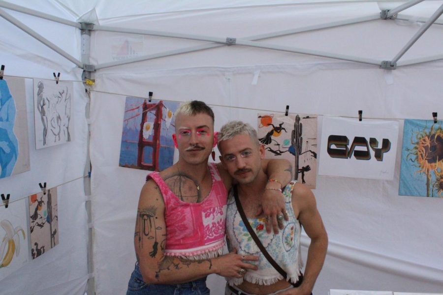 Nicholas Holman and his boyfriend, Dylan Tipton, stand in front of their art prints set up at a booth along Northalsteds Pride Fest streets on Saturday, June 17, 2023.