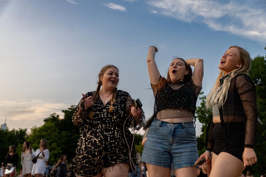 Three best friends dance to music from Taylor Swifts performance in the park outside Soldier Field at 1410 Special Olympics Dr, on Friday, June 2, 2023.