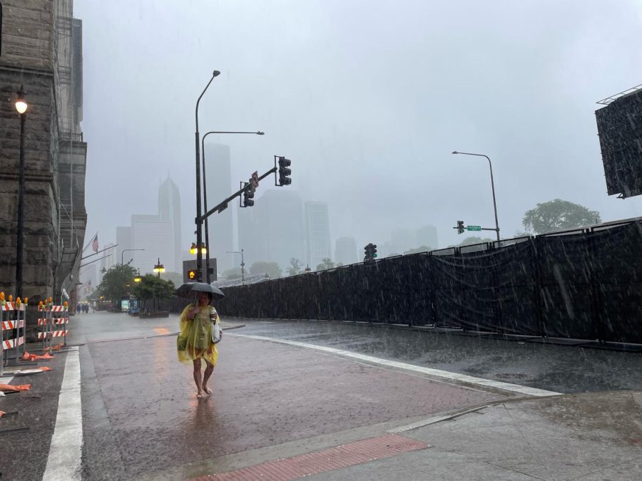 NASCAR fans await the rain and seek shelter as intense rain showers hit the city Sunday, July 2.