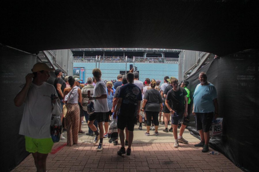 Attendees of the XFinity Series Loop 121 Chicago Street Course swarm under the Fountain Club seating area to get a look at Pit Row and drivers speeding by on Saturday, July 1, 2023.