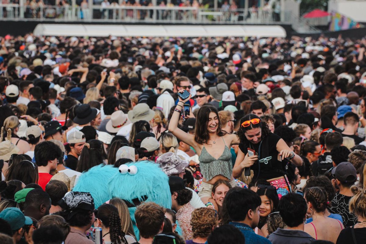 Crowd members dance in a sea of people listening in on Fred Again..s set at Lollapalloza on Friday, Aug 4, 2023. Fred Again.. was the last performer on the T-mobile stage before headliner Kendrick Lamar closed out day two of the festival.