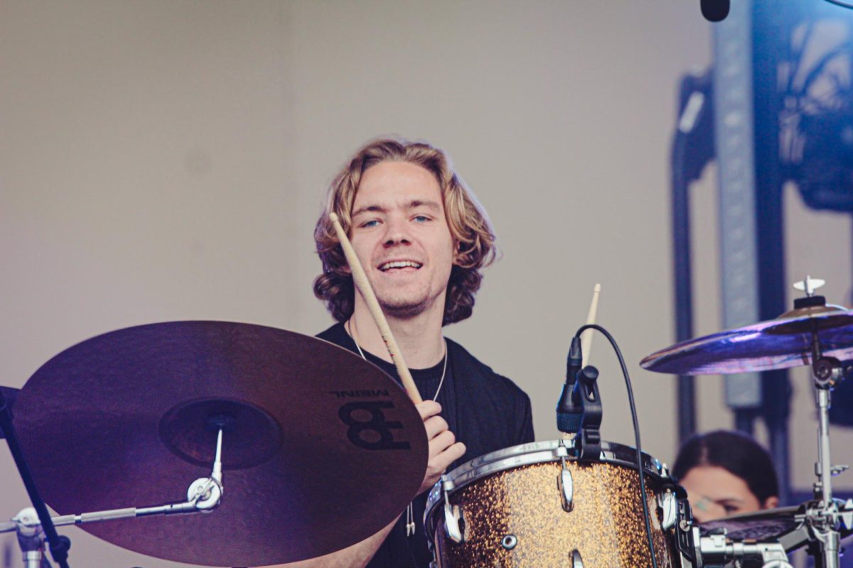 Drummer of Friday Pilots Club, Eric Doar, sings along while playing alongside his bandmates on the Titos stage at Lollapalooza on Saturday, Aug 5, 2023. All former Columbia students, this is the bands first time performing at Lollapalooza.