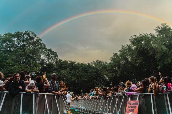 After a long day of rain showers, a rainbow forms over Lollapalooza festival grounds on Saturday, Aug. 5, 2023. Crowd members waiting before Alex Gs set at the Bacardí stage gasp in joy and take pictures.
