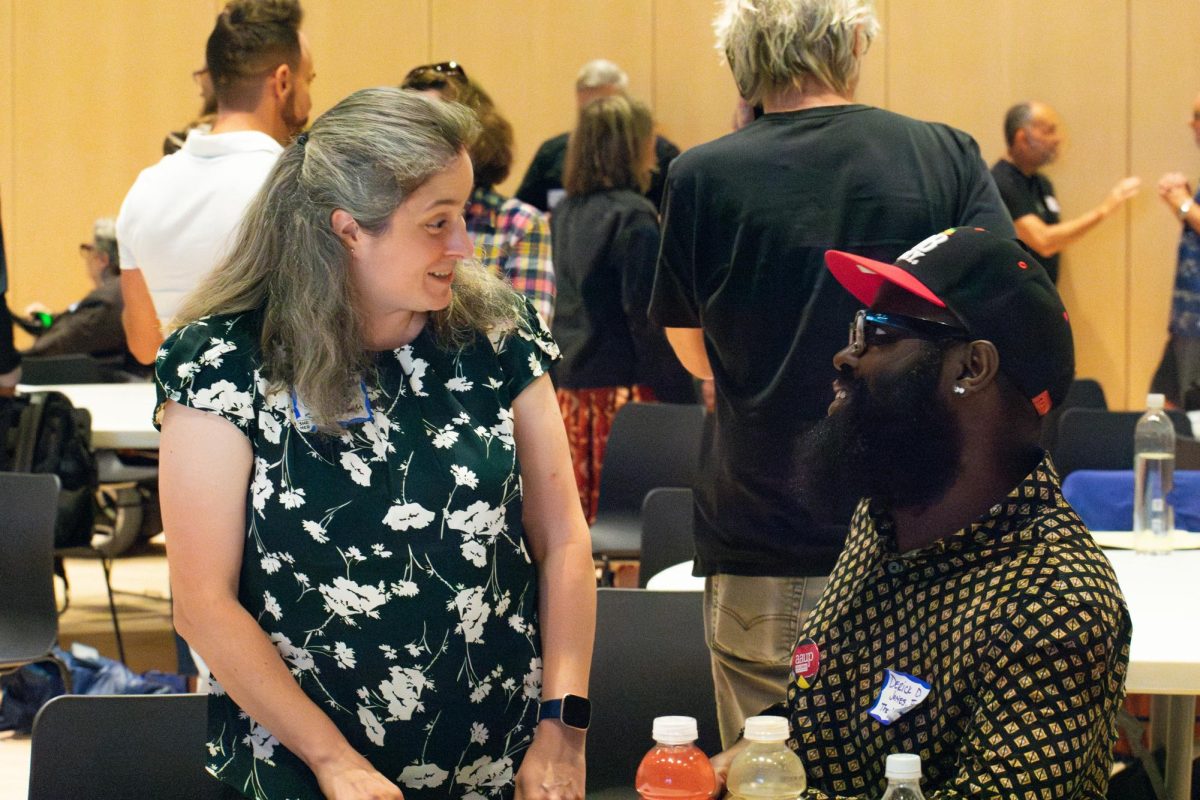 Elizabeth Davis-Berg, the chair for Science and Mathematics, and Derick D. Jones, assistant professor of chemistry, talk during a session break at Columbias annual faculty meeting at 754 South Wabash Avenue in Wednesday, Aug 16, 2023. Faculty mingle amongst each other before the next presentation.