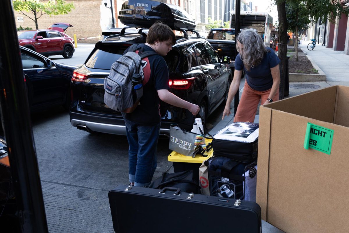 Returning first-year music buisness student, Caden Tarnow and his mother Megan Genest-Tarnow move his personal items from their car to the cardboard bins as he moves into The Dwight Lofts, located at 642 S. Clark St. on Aug 28, 2023.