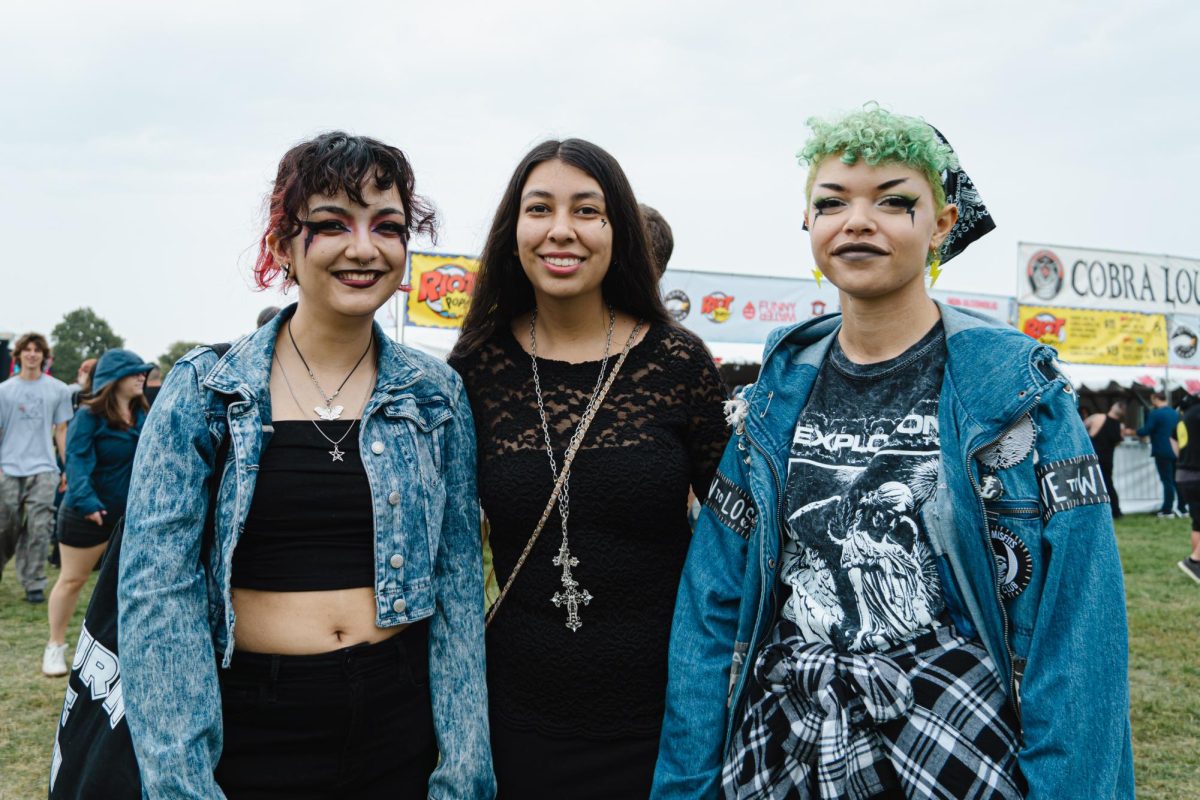 Lee Zarati, Angela Duran and Anjaly Banks pose in Douglass Park at Riot Fest on Saturday, Sept. 16, 2023. The fans drove four hours from Detroit, and are most excited for The Cure.