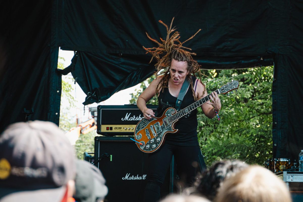 Adrian Conner, guitarist for FEA, head bangs while shredding on the guitar during their song Mujer Moderna at Riot Fest in Douglass Park on Friday, Sept. 15, 2023. Playing the festival for the first time, the band said they were ready to crash after their high energy performance.