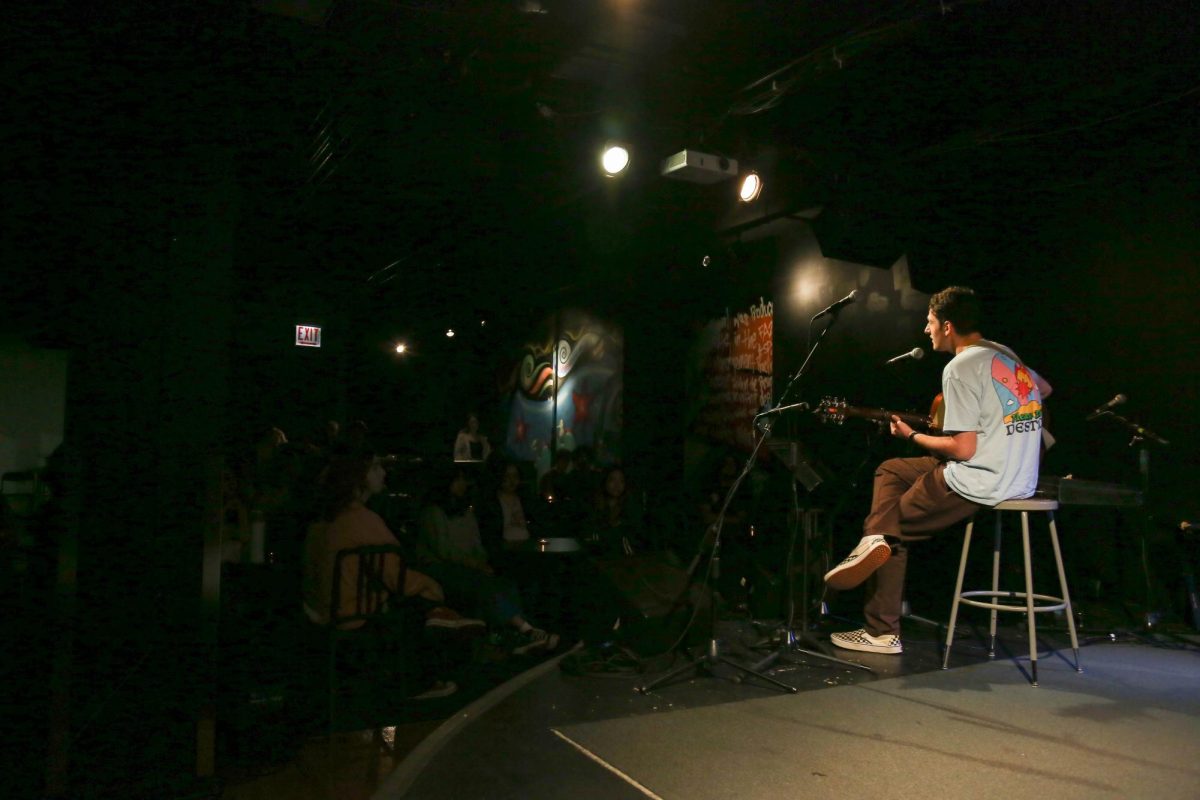 First year Asher Rigler performs to crowd during Acoustic Kitchen in the Haus Performance Space on Sept. 26, 2023. Despite being called Acoustic Kitchen, performers ranged from playing acoustic and electric guitars, ukuleles and pianos.