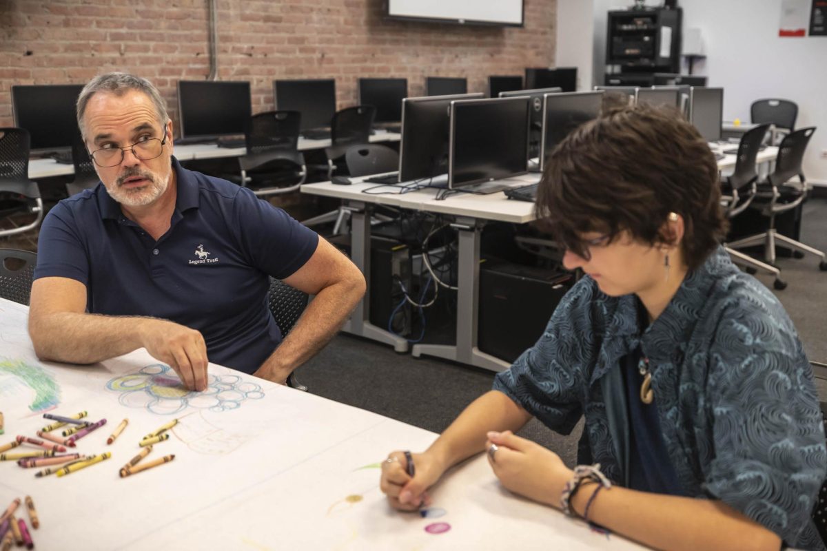 Associate Professor Dave Gerding stikes up a conversation with Leo Richnofsky a first year student from Minnesota during student connections at 916 S. Wabash Ave. on Friday, September 1, 2023. Gerdings ice breaker encoruages students to draw and work collabritively.
