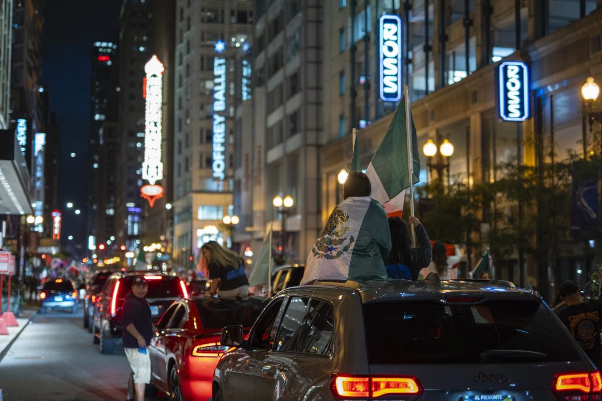 Participants of the Mexican Independence Day celebrations sit on top of their vehicle as they make their way down Randolph Street on Saturday, Sept. 17, 2023.