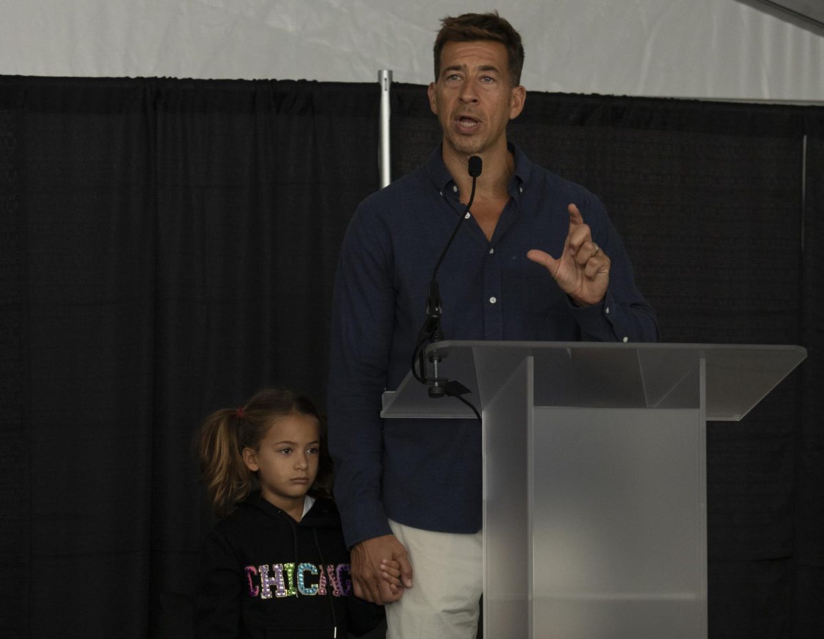 Illinois Secretary of State Alexi Giannoulias addresses the audience at the Joseph & Bessie Feinberg Foundation Stage of Printers Row Lit Fest on Sept. 9, 2023. Giannoulias held his child’s hand as he spoke of House Bill 2789, which seeks to amend library system book banning.