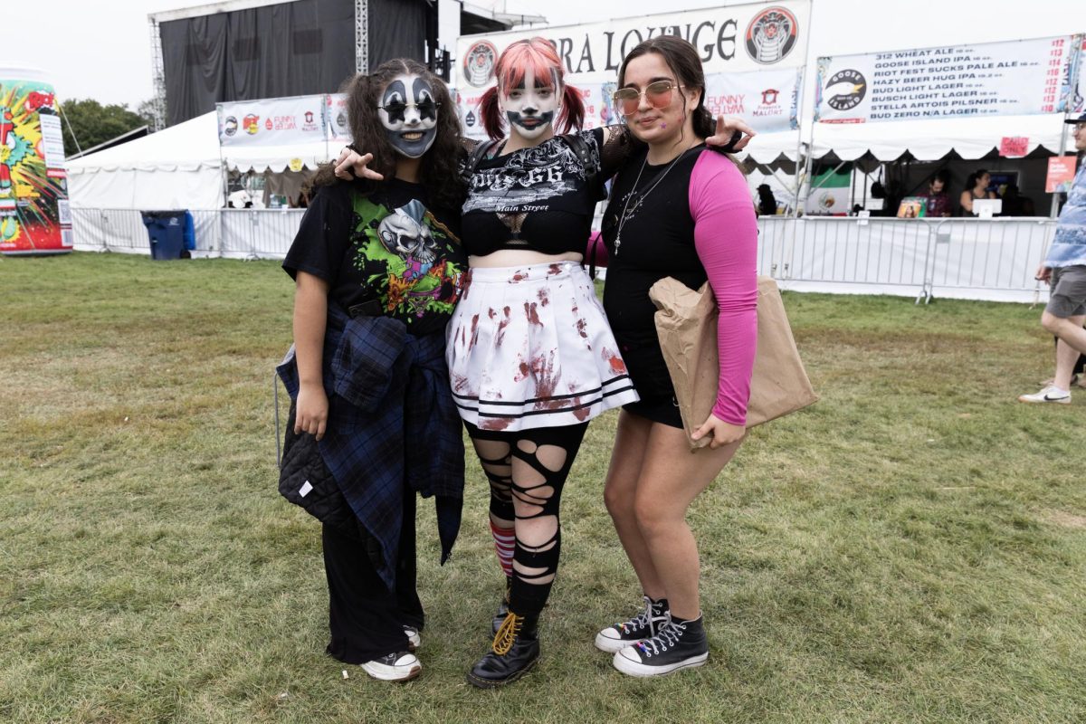 Quinn Geshel, Michaela Jenkins and Hannah Ragins show off their looks inspired by Insane Clown Posse, who they are going to see tonight, Saturday, Sept. 16, 2023, at Riot Fest in Douglass Park.