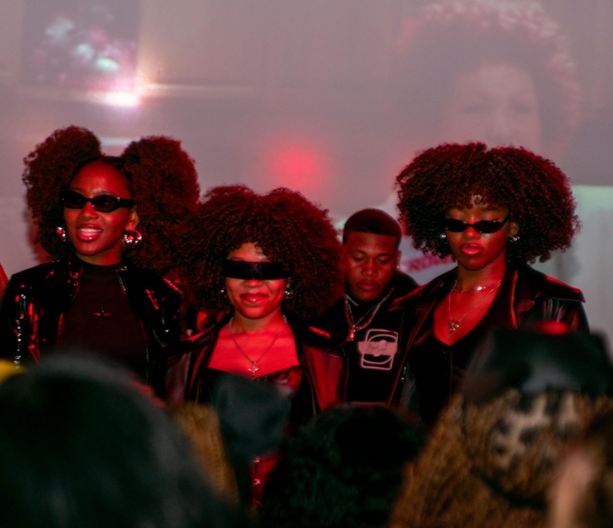 On Friday, Oct. 6, at the annual Black Student Union Blackout party, the winners of the best group costume pose for pictures while on stage.