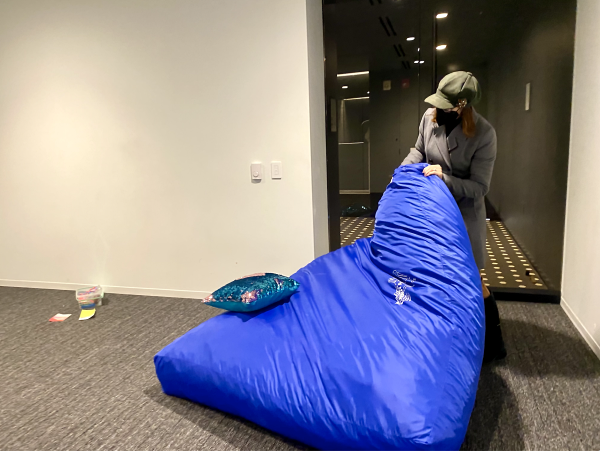 Grace Overbeke, assistant professor in the Threatre Department, moves a blue crash pad out of the Reflection Space on Monday, Oct. 9, 2023. The colleges new sensory room was moved from the Reflection Space to the third floor of the Student Center, in the New Student Programs area. 