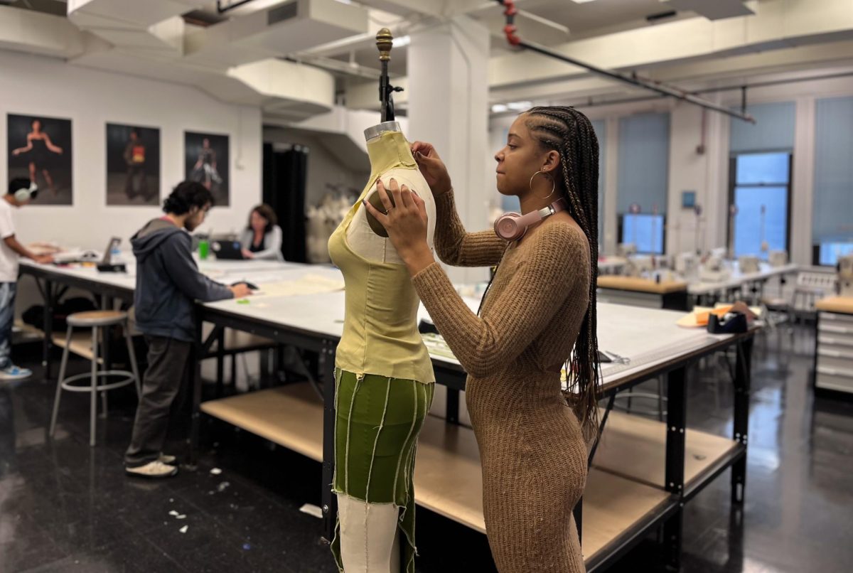 Lexie Jones, a senior Fashion Design Major works with materials to organize and measure the clothing on the sewing dress form on Tuesday, Nov. 14, 2023. Students work on assignments and projects independently or in groups in the fashion studio and adjoining garages at 623 S. Wabash Ave.