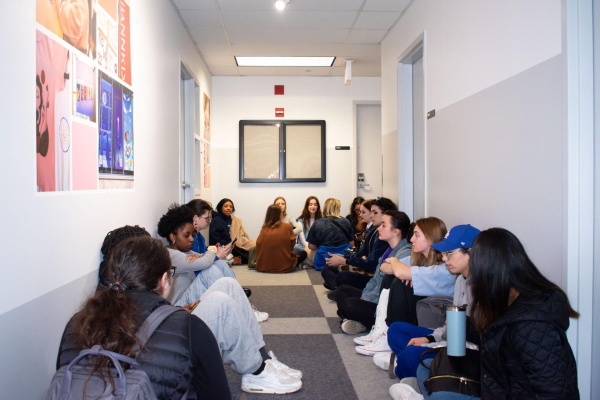 Columbia students perform a protest sit-in to express solidarity with the CFAC union strike on Thursday, Nov. 16. Students sat down amongst each other on the 9th floor after not gaining access to the 5th floor.