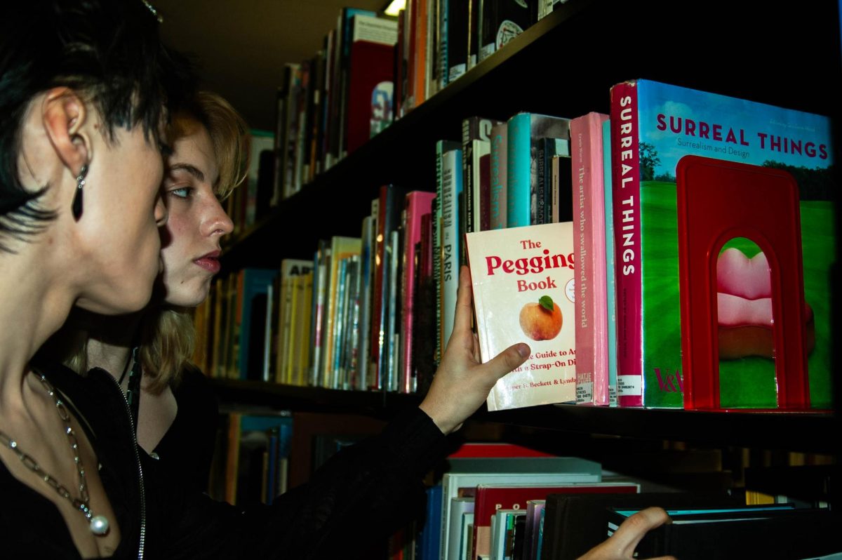 Marketing major Seng and film major Emma Jane, both sophomores, are seen on Jan. 30, 2024, at the Columbia Library located at 624 S. Michigan Ave., looking through sexual education books. 