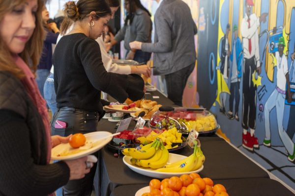 Students and faculty eat an array of brunch foods and drinks being served at the Uplift Kickoff Brunch on Monday, March 11, 2024, at the Student Center. 