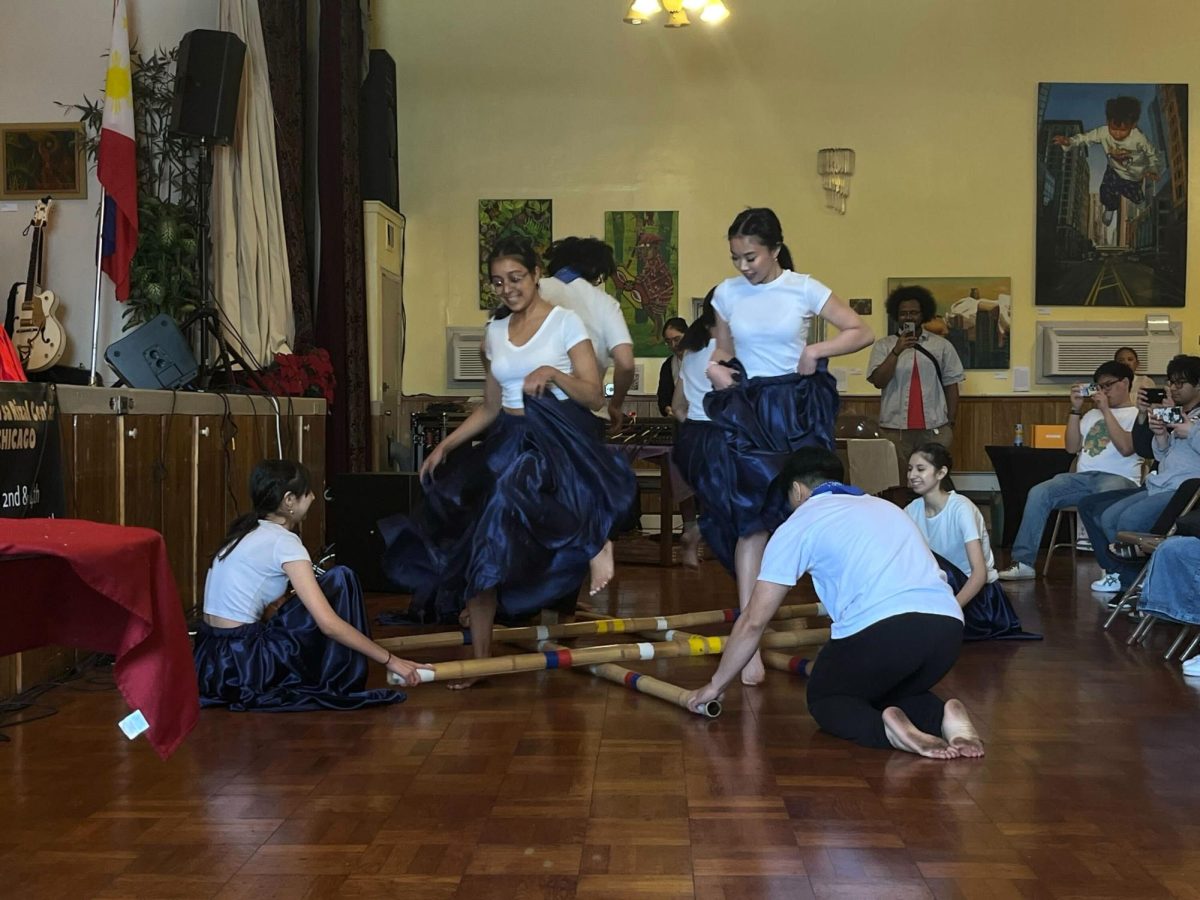 Filipinos in Alliance Cultural from the University of Illinois Chicago performs the traditional Filipino folk dance Tinikling at the Kapwa Chicago Vol. 1 showcase on Saturday, April 27, 2024.