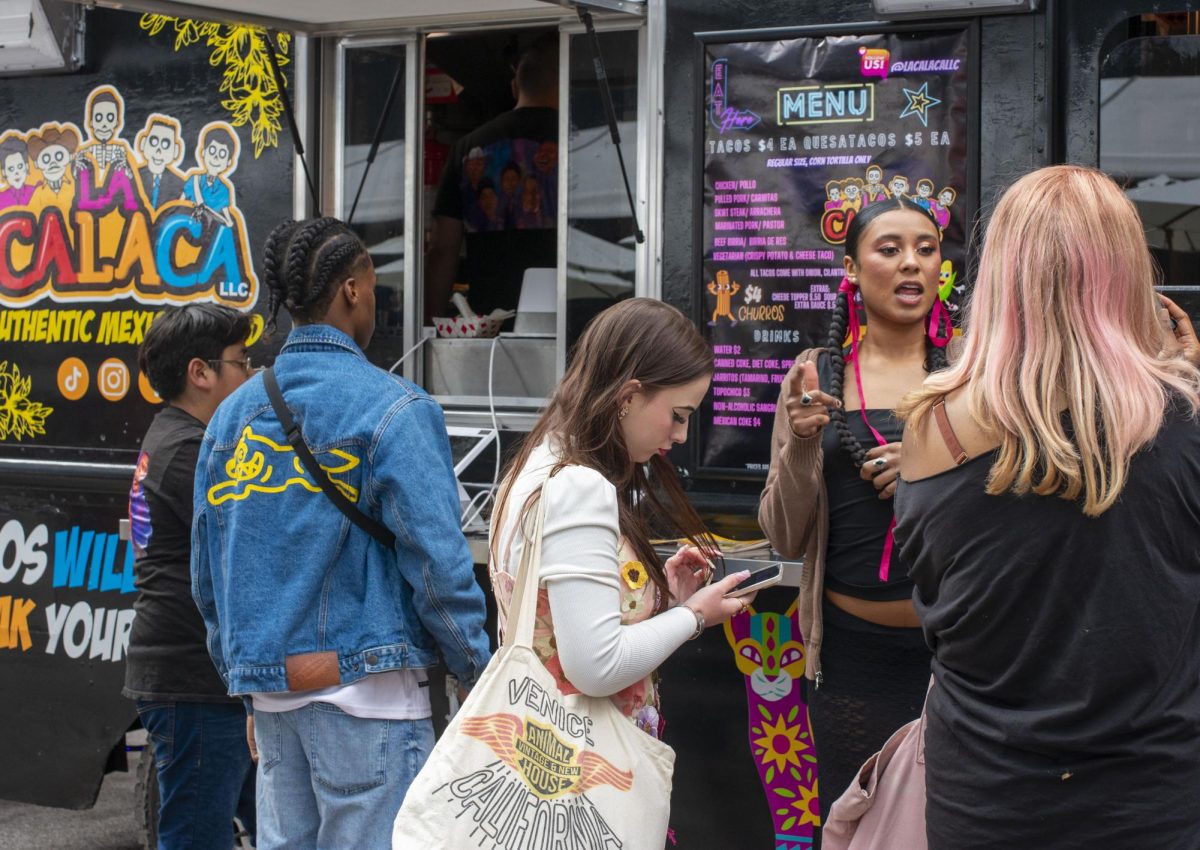 Students wait in line for La Calaca, an authentic Mexican food truck on Friday, May 10, 2024, at the Manifest Arts Festival where graduating students showcase their work.