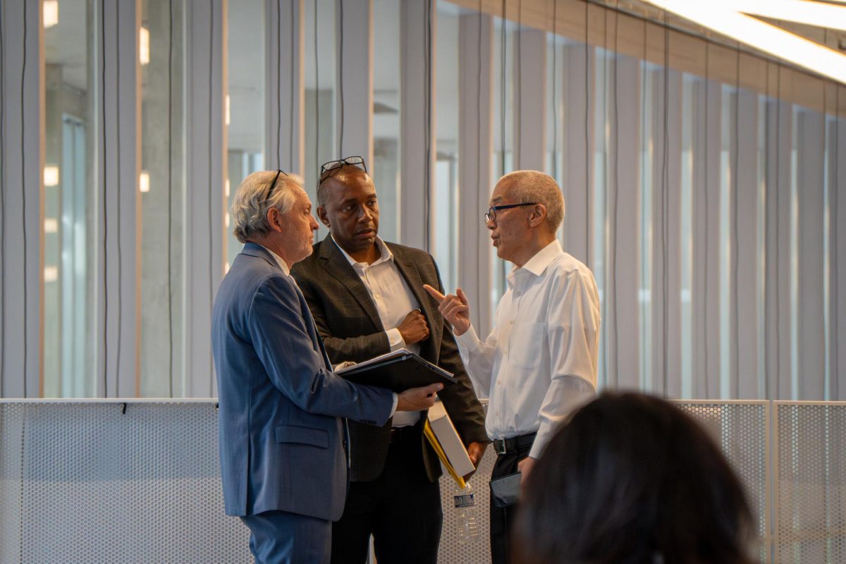 Chief of Staff Laurent Pernot, Senior Vice President and CFO Jerry Tarrer and President and CEO Kwang-Wu Kim confer during a break during the Board of Trustees meeting at the Student Center on Monday, May 20, 2024. The board voted to accept Kims recommendations for the college.