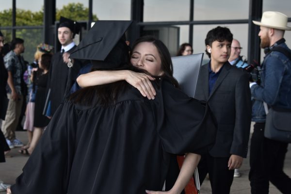 Family members and friends hug their graduates and congratulate them for their acomplishments after the ceremony on Sunday, May 12, 2024. Graduates smile, cry, and laugh together amongst their loved ones. 