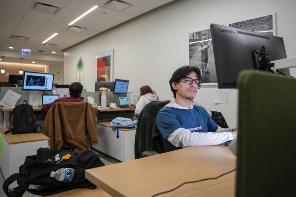 Sophomore creative writing major Angel Quintana works at his desk in the Columbia College Chicago Admissions Office located at 600 S. Michigan Ave on Wednesday, April 24, 2024.
