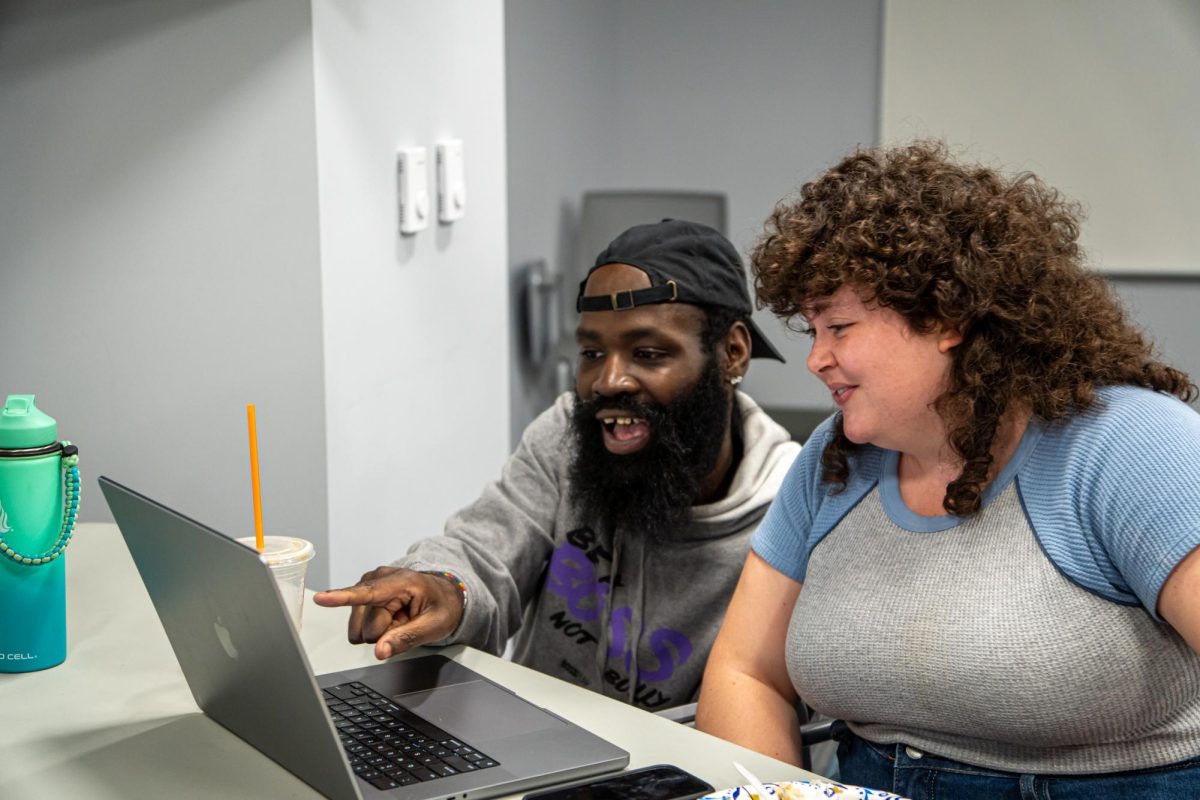 Derick D. Jones Jr., assistant professor in the Science and Mathematics Department, assists student Ellie Moody during the LGBTQ+ Social Health Equality class in the 618 S. Michigan Ave. building on Wednesday, June 26, 2024. The class is one of four in-person courses being offered during the summer.