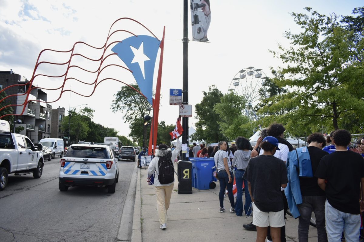 Families, friends, and Chicago Residents wait in a line that wraps around the corner of 2800 W. Division St, on Thursday, June 6, 2024. Everyone gathers for the first day of the weekend long celebration of the Puerto Rican Festival and heritage.