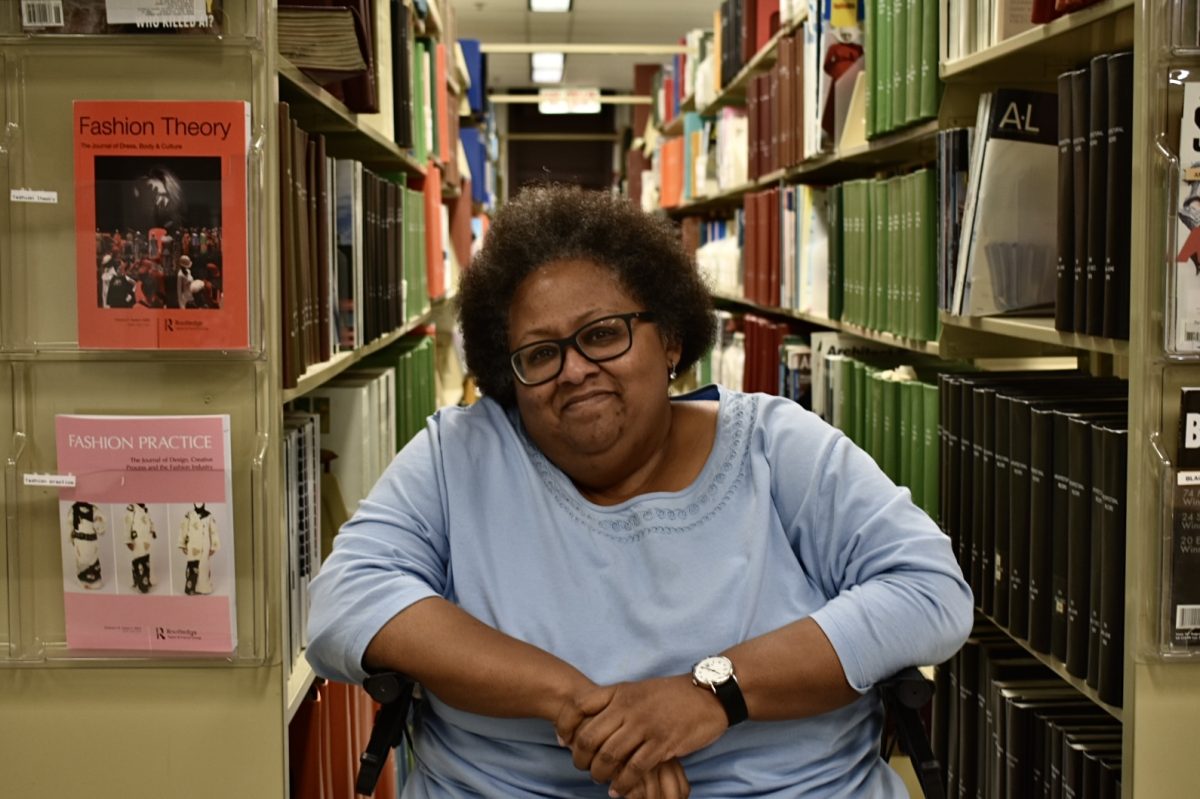 Kim Hale, former librarian of Columbia, sits by the bookshelves and smiles on her last day at the library on Thursday, June 13, 2024.