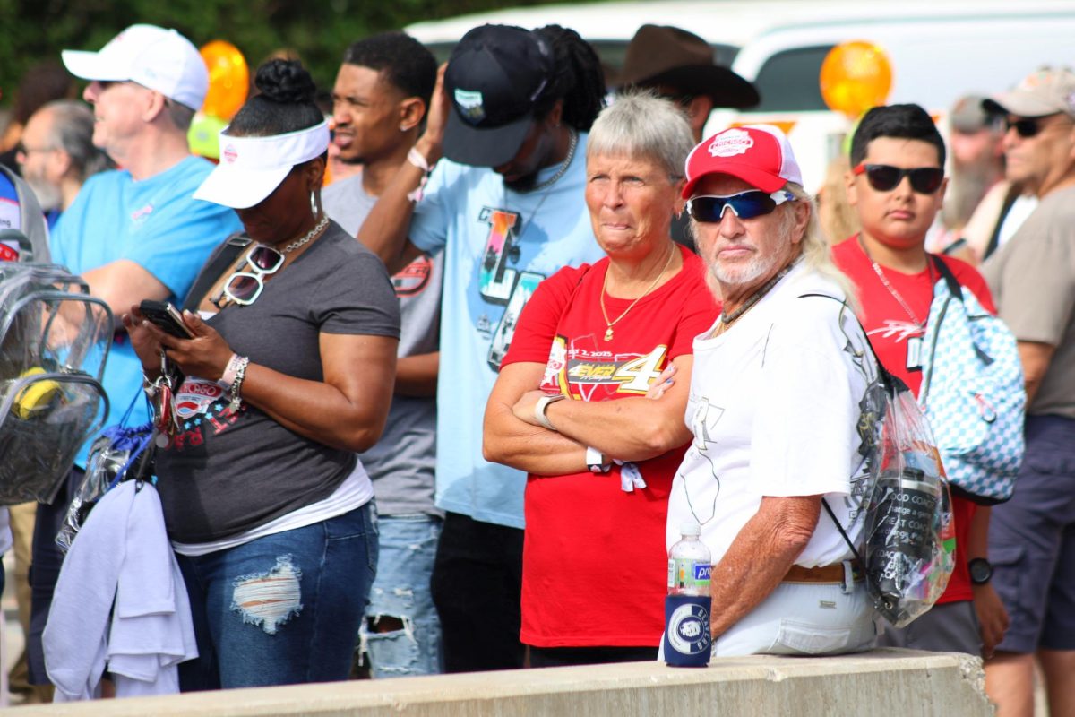 Fans wait to get into the NASCAR Village at Butler Field on Sunday, July 7, 2024. This area of Grant Park was open to the public, without admission fees, and featured stock cars and a racing simulator. 