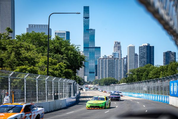 NASCAR drivers drive slowly down S. DuSable Lake Shore Drive as they follow a safety car during the Xfinity Series race at the NASCAR Chicago Street Race on Saturday, July 6, 2024. A sunny day with blue skies made for a pleasant suprise in comparison to the previous rain-delayed year. 