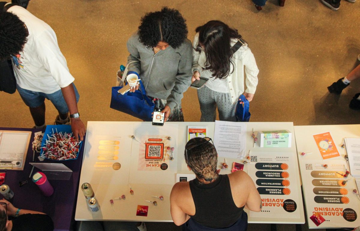 Students use a QR code to learn more about the Academic Advising Center at New Student Convocation at the Student Center on Friday, Aug. 30, 2024.