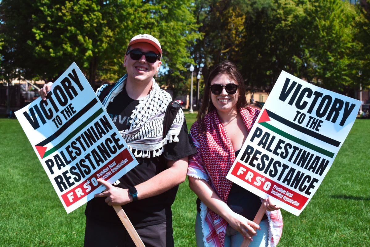 Cameron Mccabe and Isabel Palomo Diaz hold signs that say ‘Victory to the Palestinian Resistance’ on Monday, Aug. 19, 2024. Mccabe and Diaz travelled from Wisconsin to Chicago in solidarity with Palestinian organizations planning to march to the outside of the Democratic National Convention.