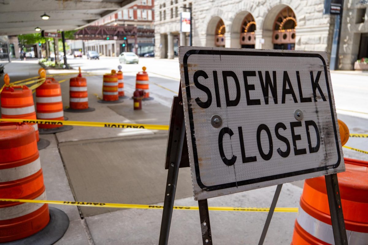 A sidewalk closure sign sits along E. Ida B. Wells Drive in the South Loop on Monday, July 1, 2024.