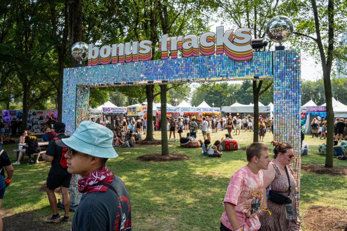 Festival goers browse around the Bonus Tracks section at Lollapalooza in Grant Park on Saturday, Aug. 3, 2024. This area offers multiple experiences such as a photo booth and nail artists.
