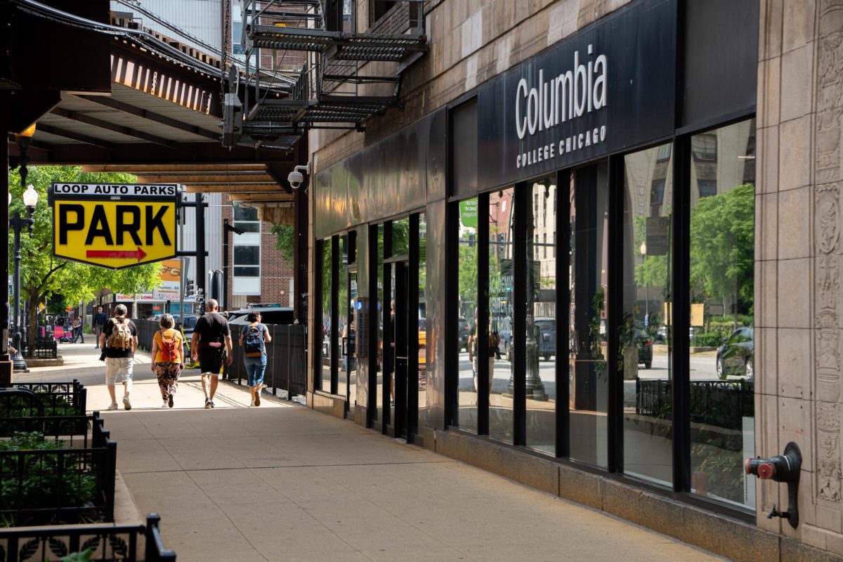 People stroll past the 33 E. Ida B. Wells building in the South Loop on Monday, June 3, 2024.