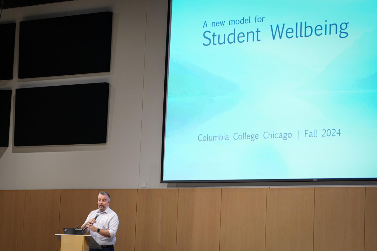 Douglas Eck presents the college's new model for Student Wellbeing at the collegewide faculty meeting in the Student Center on Friday, Aug. 16, 2024.