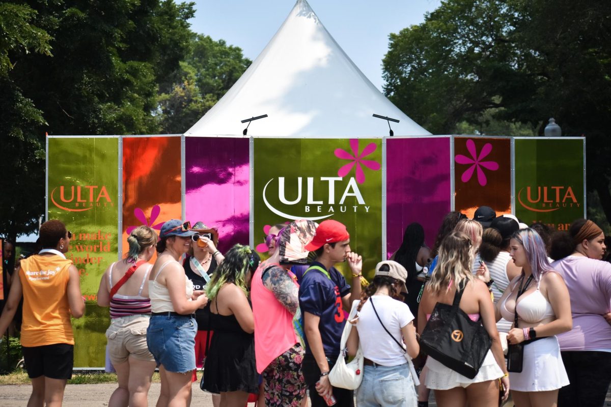 Lollapalooza attendees wait in line at the Ulta Beauty tent to get a free service to test out products in Grant Park on Saturday, Aug. 3, 2024. Ulta Beauty offers hair tinsel, hair styling and make overs with Ulta products for Lollapalooza weekend.
