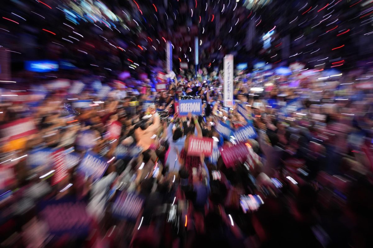 Delegates and attendees at the 2024 Democratic National Convention raise their signs after California casts their votes in favor of Kamala Harris in the United Center in Chicago on Tuesday, Aug. 20, 2024. 