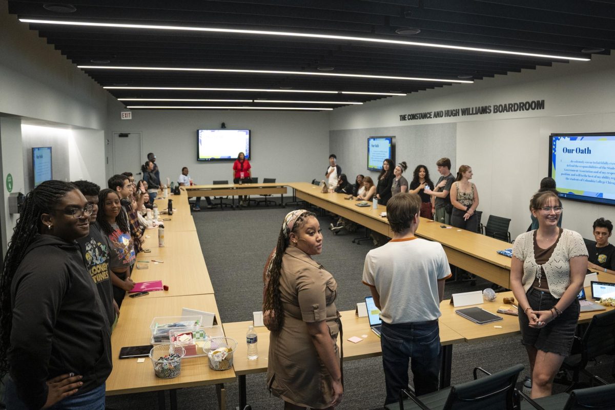 SGA senate members stand to recite an oath to serve and represent the students at Columbia College before the conclusion of their meeting in the Student Center on Tuesday, Sep. 17, 2024.