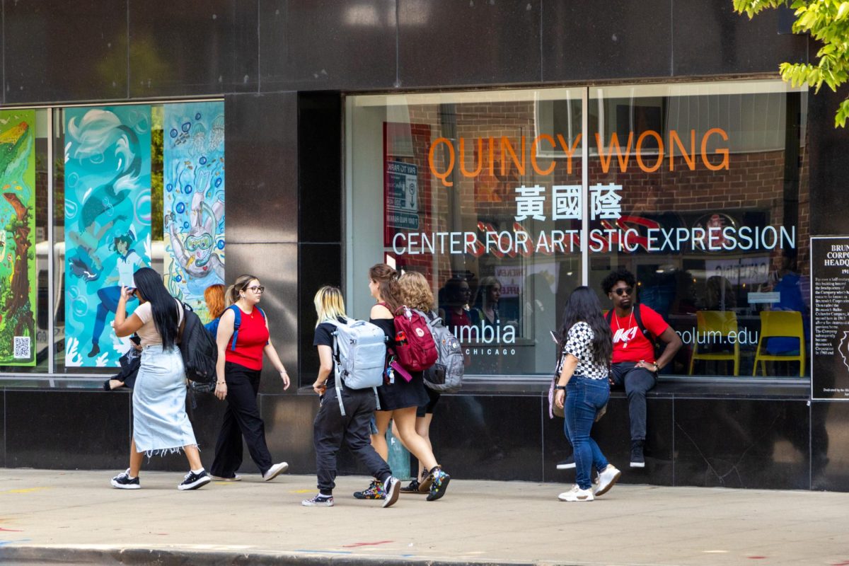 Students walk and sit outside the 623 S. Wabash building on Wednesday, Sept. 11, 2024.