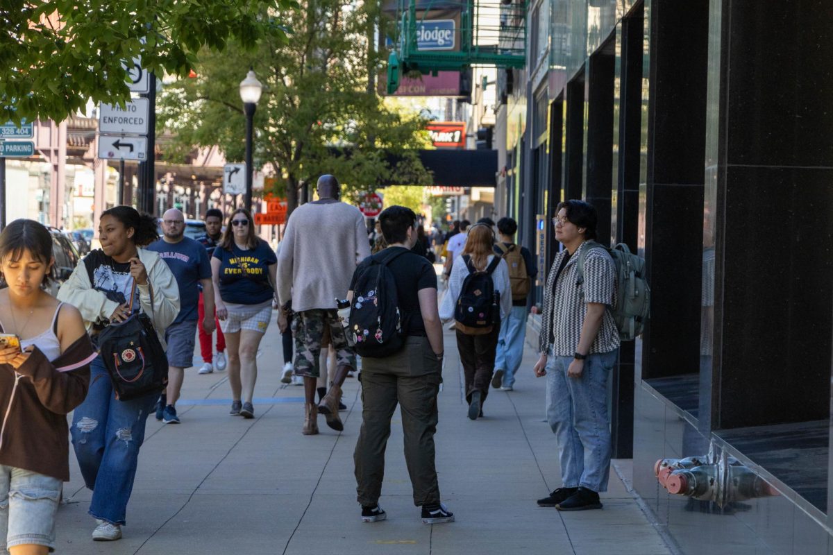 Students standing and walking in front of 623 S. Wabash Ave on the first day of the semester, Sept. 3, 2024.