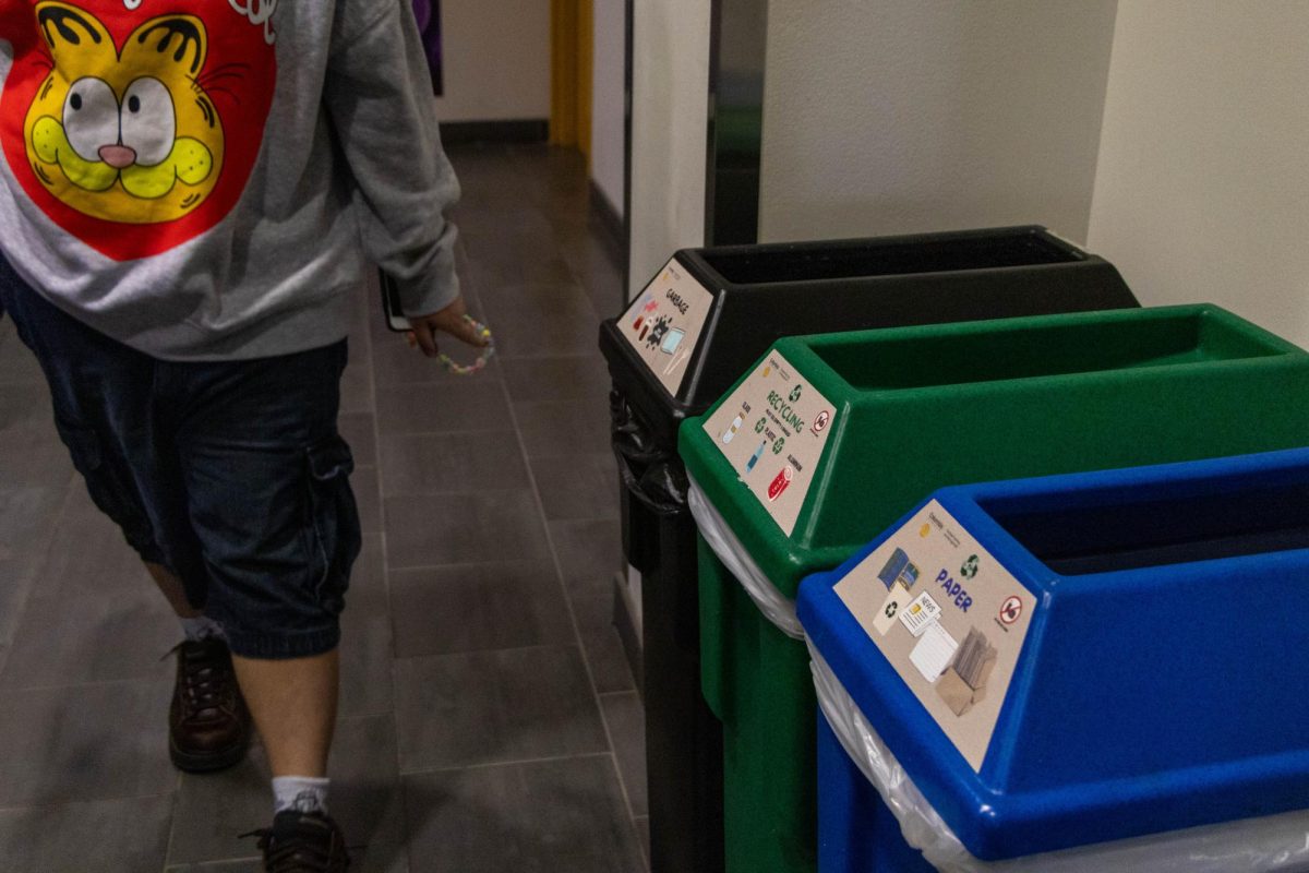 Student walking passed the Garbage, Recyling, and Paper bin in the lobby of 623 S. Wabash Ave, Sep. 3, 2024.