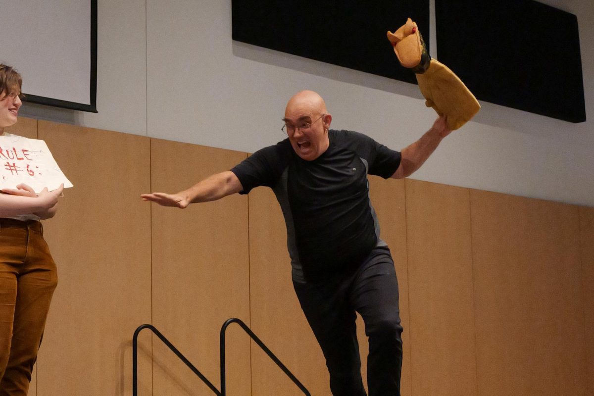 Running for his life, K. Crom Saunders attempts to escape the monster moments before crashing into the wall during his 'Cromania' performance at the Deaf Awareness Day event in the Student Center on Sept. 26, 2024.