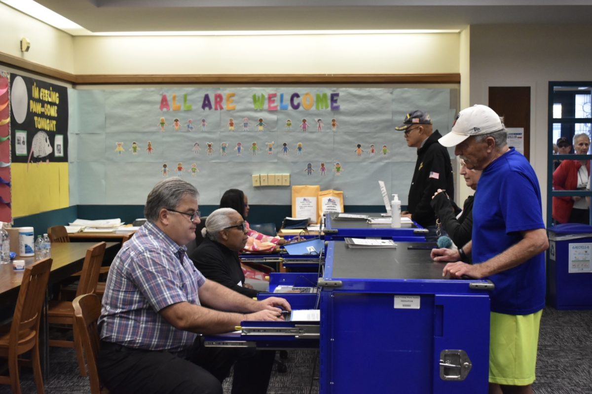 People preparing to vote at Clearing Public Library for the first day that polling sites opened in 50 wards on Monday, Oct. 21, 2024. 