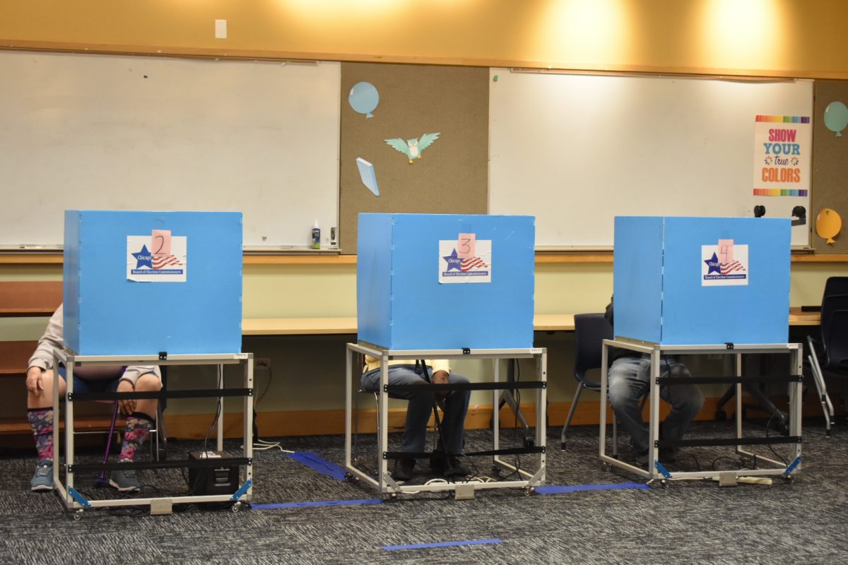 Voters cast ballots at a polling station at the Chicago Public Library in the Clearing neighborhood on Monday, Oct. 21, 2024.